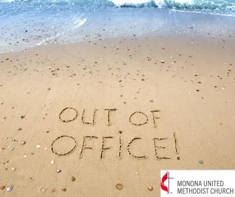Sandy beach with words "Out of Office" etched in the sand