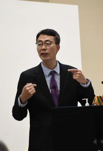 Photo of Pastor Yohan pointing at himself with each hand