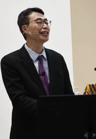 Pastor Yohan smiling and looking out to the congregation