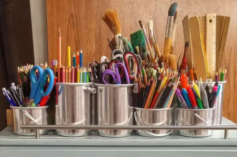 Arts supplies in silver cans