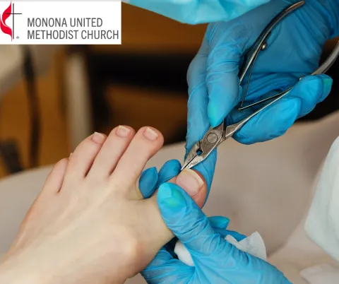 Photo of a blue-gloved hand clipping toenails on a foot