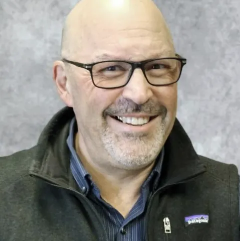 Photo of staff member Mark Buffat- a man with glasses and some facial stubble